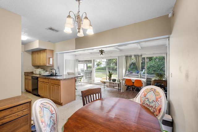 590 SE Anchor Ln, Port Saint Lucie, FL 34983 - dining area featuring a chandelier, plenty of natural light, a ceiling fan, and a textured ceiling