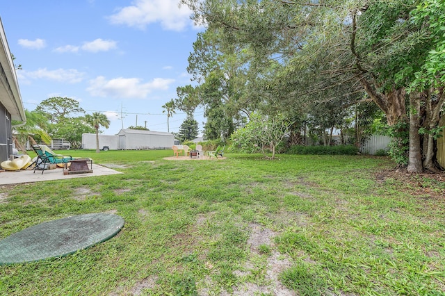 590 SE Anchor Ln, Port Saint Lucie, FL 34983 - view of yard featuring an outdoor fire pit and a patio