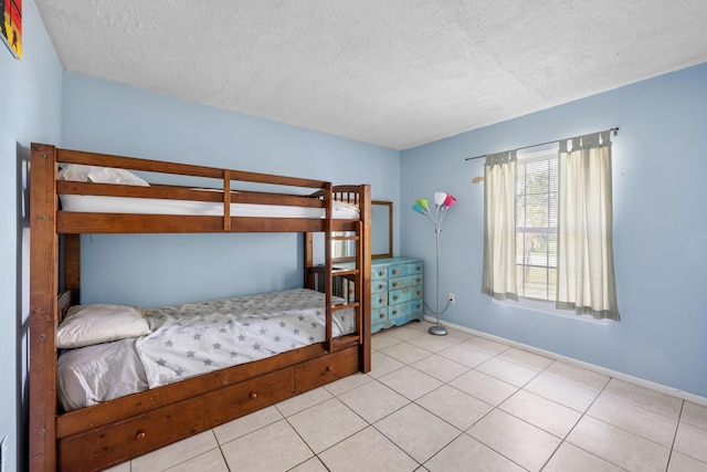 590 SE Anchor Ln, Port Saint Lucie, FL 34983 - tiled bedroom featuring a textured ceiling and baseboards
