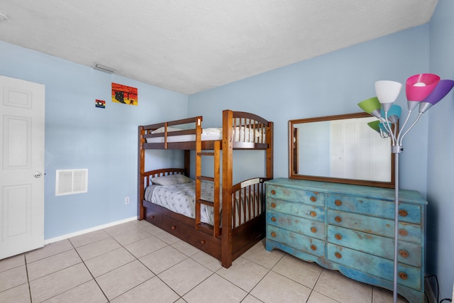 590 SE Anchor Ln, Port Saint Lucie, FL 34983 - tiled bedroom with baseboards and a textured ceiling