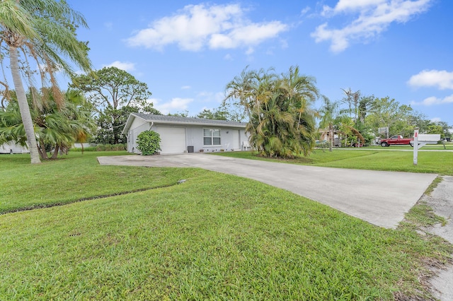 590 SE Anchor Ln, Port Saint Lucie, FL 34983 - view of front of home featuring a front yard, an attached garage, and driveway