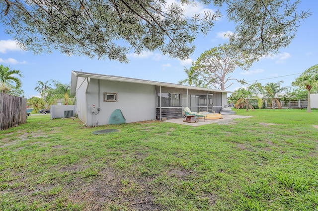 590 SE Anchor Ln, Port Saint Lucie, FL 34983 - rear view of property featuring a sunroom, stucco siding, and a patio