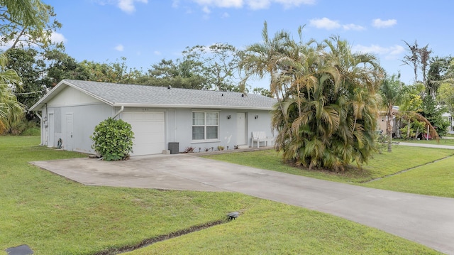 590 SE Anchor Ln, Port Saint Lucie, FL 34983 - ranch-style house with an attached garage, a front yard, concrete driveway, roof with shingles, and stucco siding