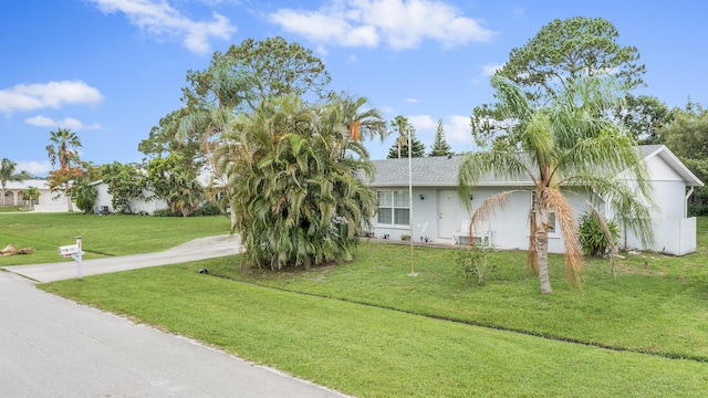 590 SE Anchor Ln, Port Saint Lucie, FL 34983 - view of front of home with a front lawn and stucco siding