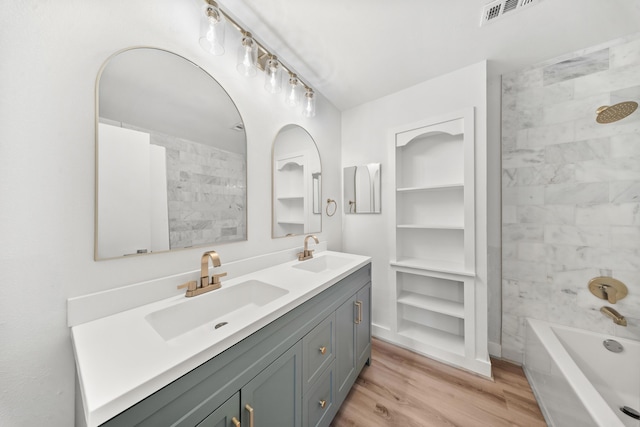 948 Canal Cir, Sebastian, FL 32958 - bathroom featuring double vanity, wood finished floors, and bathing tub / shower combination