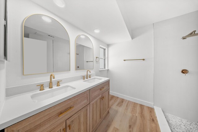 948 Canal Cir, Sebastian, FL 32958 - bathroom featuring double vanity, wood finished floors, walk in shower, and recessed lighting