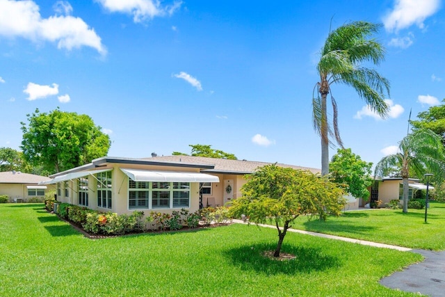 1012 Circle Ter E Unit A, Delray Beach, FL 33445 - view of front of house featuring a front lawn and stucco siding