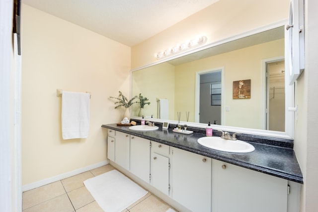 782 NW Kilpatrick Ave, Port Saint Lucie, FL 34983 - full bathroom featuring double vanity, tile patterned floors, and baseboards