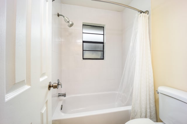 782 NW Kilpatrick Ave, Port Saint Lucie, FL 34983 - bathroom featuring toilet and shower / tub combo with curtain