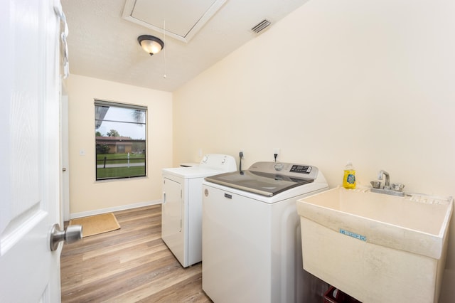 782 NW Kilpatrick Ave, Port Saint Lucie, FL 34983 - washroom with attic access, independent washer and dryer, light wood finished floors, and baseboards