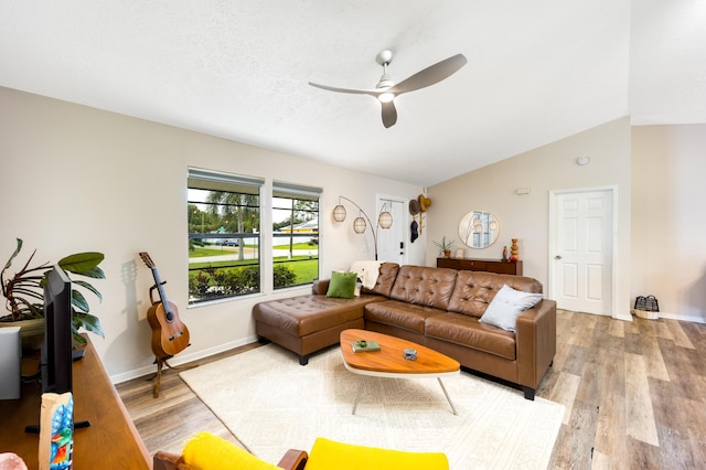 782 NW Kilpatrick Ave, Port Saint Lucie, FL 34983 - living area featuring a ceiling fan, light wood-style flooring, baseboards, and vaulted ceiling