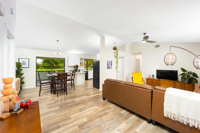 782 NW Kilpatrick Ave, Port Saint Lucie, FL 34983 - living room featuring vaulted ceiling, light wood finished floors, ceiling fan, a chandelier, and baseboards