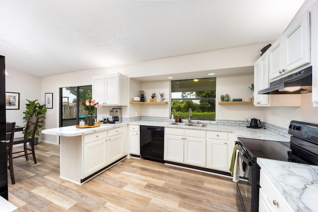 782 NW Kilpatrick Ave, Port Saint Lucie, FL 34983 - kitchen with open shelves, black appliances, under cabinet range hood, and a sink