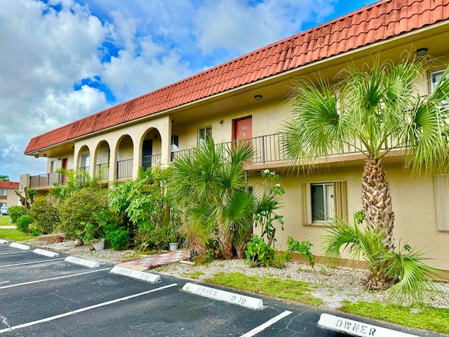 6074 Forest Hill Blvd Unit 107, West Palm Beach, FL 33415 - view of property featuring uncovered parking