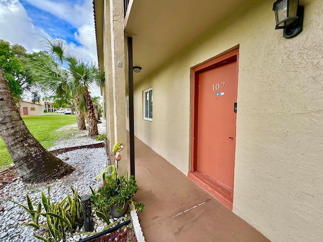 6074 Forest Hill Blvd Unit 107, West Palm Beach, FL 33415 - entrance to property with stucco siding
