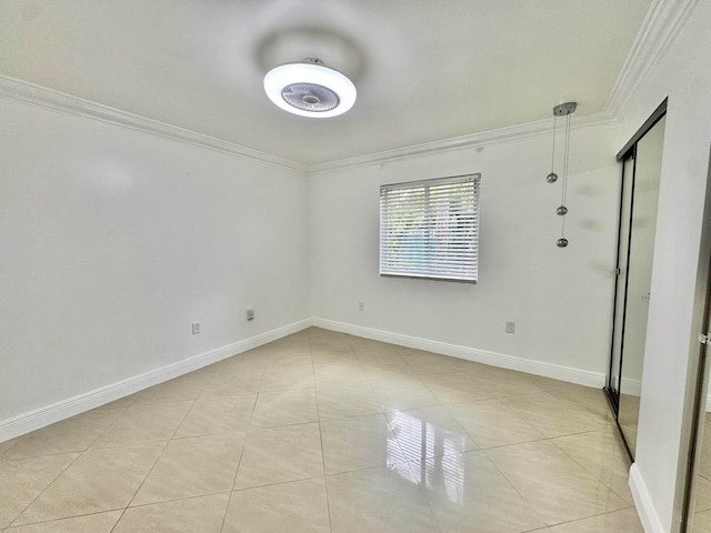 6074 Forest Hill Blvd Unit 107, West Palm Beach, FL 33415 - spare room featuring ornamental molding, light tile patterned floors, and baseboards