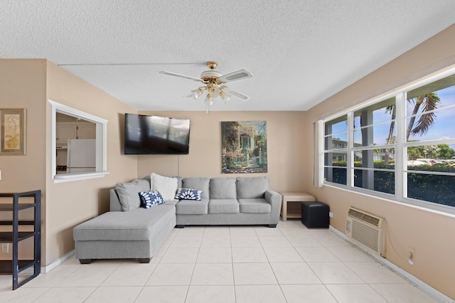 189 Prescott J 189, Deerfield Beach, FL 33442 - living room featuring an AC wall unit, a ceiling fan, a textured ceiling, light tile patterned floors, and baseboards