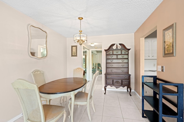 189 Prescott J 189, Deerfield Beach, FL 33442 - dining area featuring a chandelier, light tile patterned floors, a textured ceiling, and baseboards