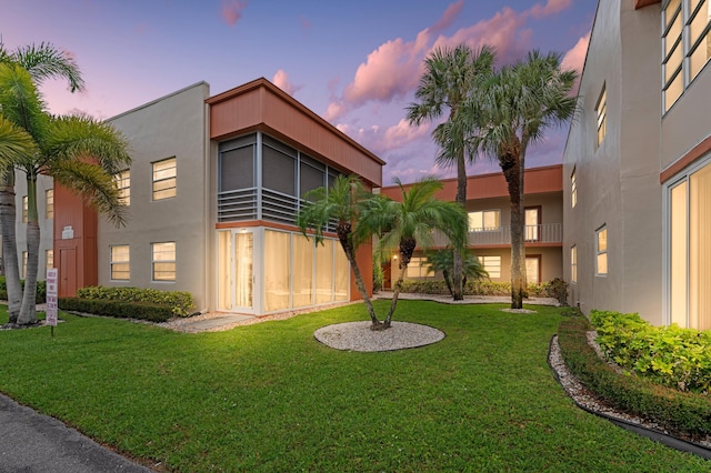 213 Piedmont E, Delray Beach, FL 33484 - view of front of home with stucco siding and a yard