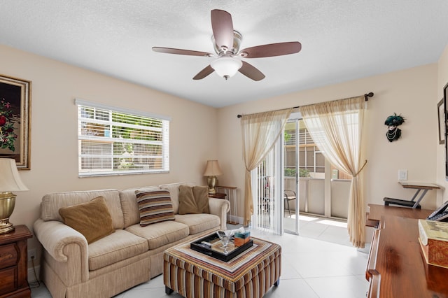 213 Piedmont E, Delray Beach, FL 33484 - living room with a ceiling fan, a textured ceiling, and light tile patterned floors