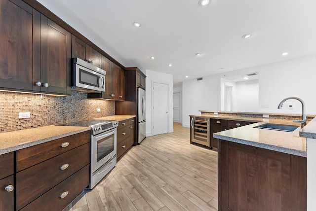 455 E Palmetto Park Rd Unit 3E, Boca Raton, FL 33432 - kitchen with stainless steel appliances, a sink, beverage cooler, light wood-style floors, and dark brown cabinets