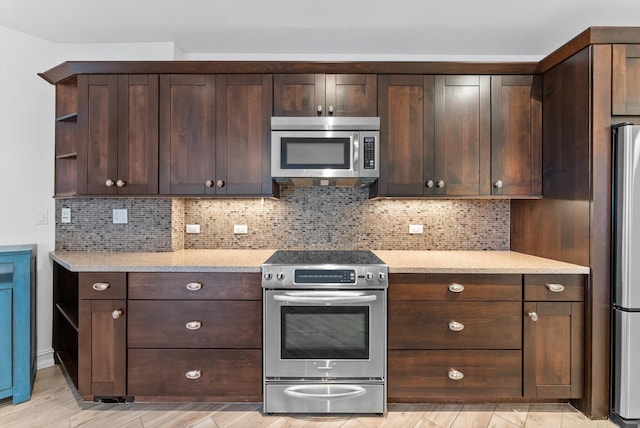 455 E Palmetto Park Rd Unit 3E, Boca Raton, FL 33432 - kitchen featuring stainless steel appliances, open shelves, dark brown cabinets, and backsplash