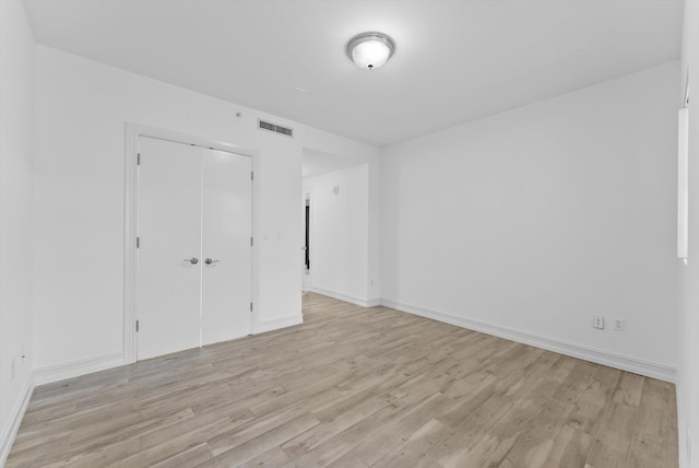 455 E Palmetto Park Rd Unit 3E, Boca Raton, FL 33432 - unfurnished bedroom featuring light wood-style floors, a closet, and baseboards