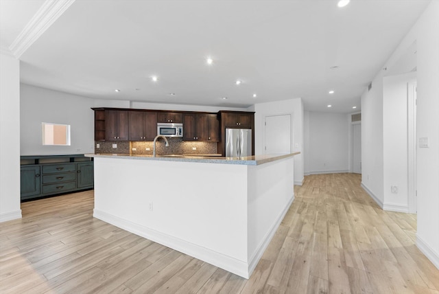 455 E Palmetto Park Rd Unit 3E, Boca Raton, FL 33432 - kitchen with stainless steel appliances, open shelves, tasteful backsplash, dark brown cabinetry, and light wood-type flooring