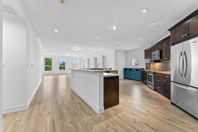 455 E Palmetto Park Rd Unit 3E, Boca Raton, FL 33432 - kitchen with appliances with stainless steel finishes, light wood finished floors, dark brown cabinetry, plenty of natural light, and recessed lighting