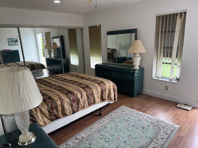 5397 Lakefront Blvd Unit A, Delray Beach, FL 33484 - bedroom featuring wood finished floors, baseboards, a closet, and recessed lighting