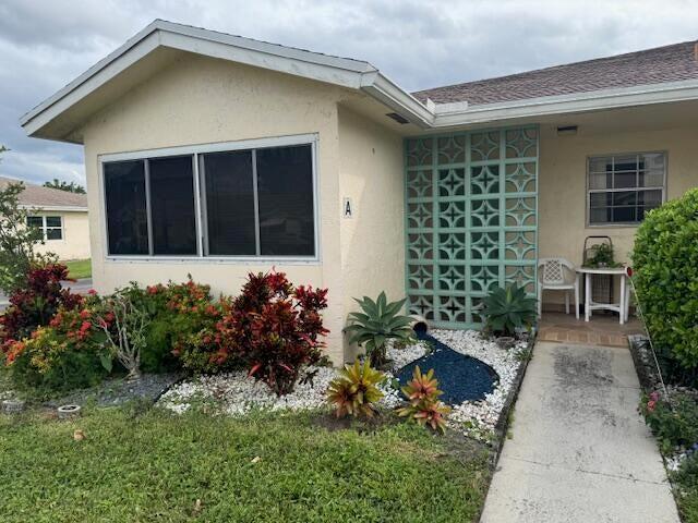 5397 Lakefront Blvd Unit A, Delray Beach, FL 33484 - entrance to property featuring stucco siding and roof with shingles