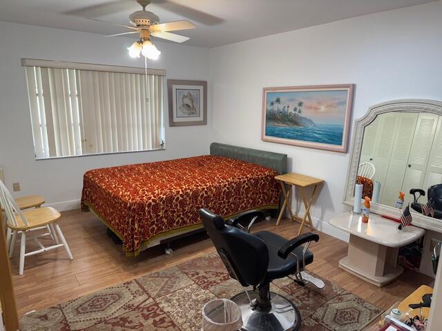 5397 Lakefront Blvd Unit A, Delray Beach, FL 33484 - bedroom featuring wood finished floors, a ceiling fan, and baseboards