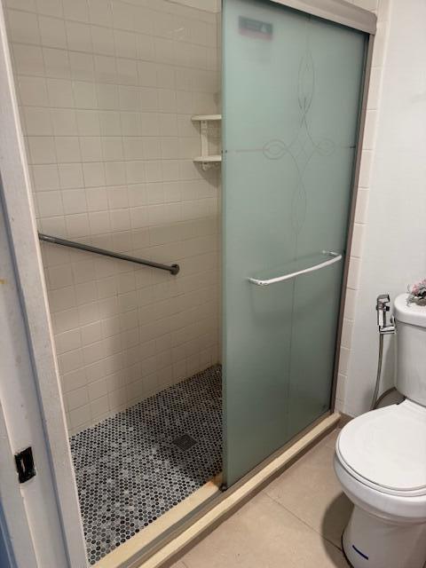 5397 Lakefront Blvd Unit A, Delray Beach, FL 33484 - bathroom with a shower stall, toilet, and tile patterned floors