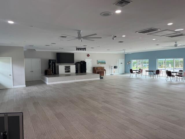5397 Lakefront Blvd Unit A, Delray Beach, FL 33484 - unfurnished living room featuring a ceiling fan, recessed lighting, wood finished floors, ornamental molding, and baseboards