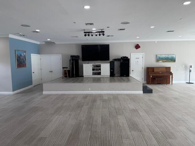5397 Lakefront Blvd Unit A, Delray Beach, FL 33484 - unfurnished living room featuring crown molding, baseboards, recessed lighting, and light wood-type flooring