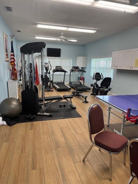 5397 Lakefront Blvd Unit A, Delray Beach, FL 33484 - gym with wood finished floors and a textured ceiling