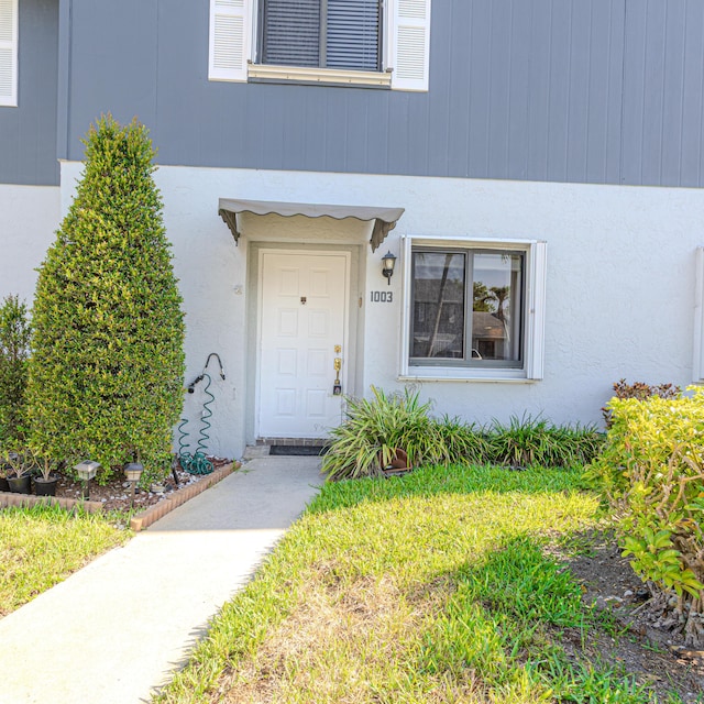 2641 Gately Dr W Unit 1003, West Palm Beach, FL 33415 - property entrance featuring stucco siding