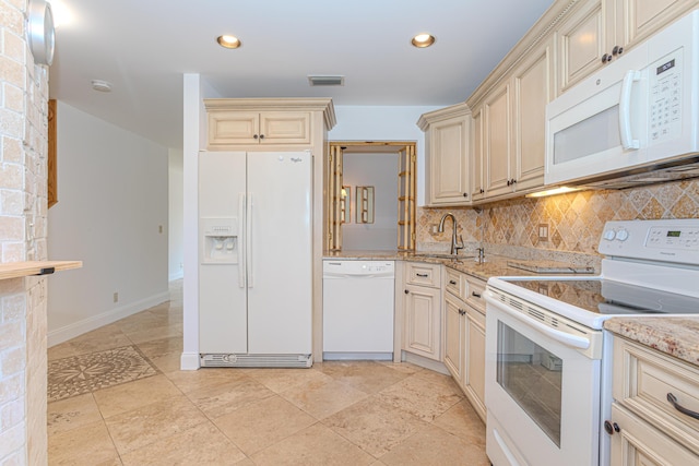 2641 Gately Dr W Unit 1003, West Palm Beach, FL 33415 - kitchen featuring white appliances, cream cabinets, decorative backsplash, a sink, and light stone countertops