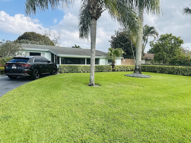 922 Arlington Dr, West Palm Beach, FL 33415 - ranch-style house with a front lawn