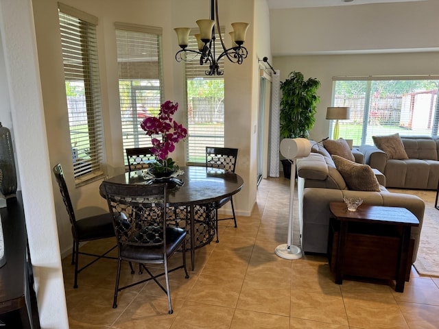 1710 SW Columbia St, Port Saint Lucie, FL 34987 - dining space with a chandelier, plenty of natural light, light tile patterned floors, and baseboards