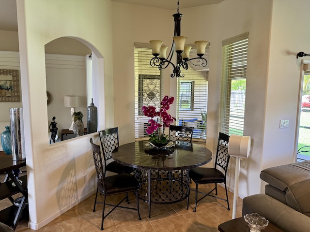 1710 SW Columbia St, Port Saint Lucie, FL 34987 - tiled dining space with a chandelier, arched walkways, and baseboards