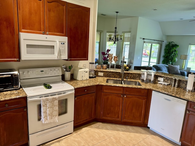 1710 SW Columbia St, Port Saint Lucie, FL 34987 - kitchen with white appliances, a sink, light stone countertops, and lofted ceiling