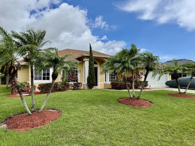 1710 SW Columbia St, Port Saint Lucie, FL 34987 - mediterranean / spanish home with an attached garage, stucco siding, and a front yard