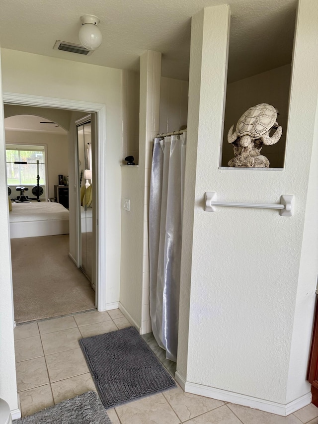 1710 SW Columbia St, Port Saint Lucie, FL 34987 - bathroom featuring tile patterned flooring, a shower with curtain, and baseboards