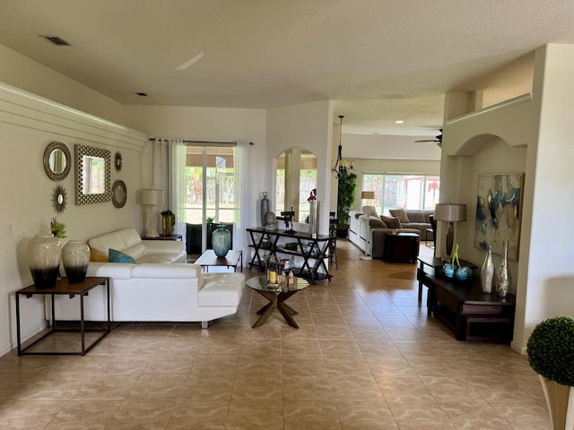 1710 SW Columbia St, Port Saint Lucie, FL 34987 - living room featuring a ceiling fan, tile patterned flooring, and arched walkways