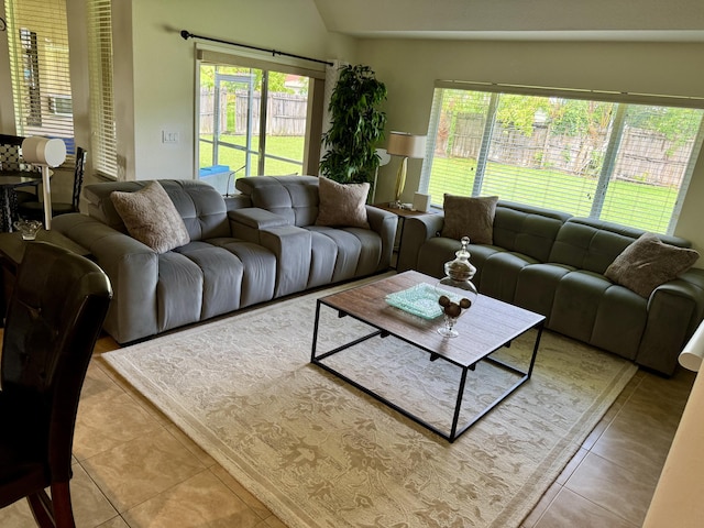 1710 SW Columbia St, Port Saint Lucie, FL 34987 - living area with plenty of natural light, tile patterned flooring, and vaulted ceiling