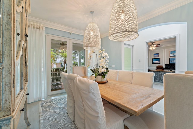 106 Henry Sewall Way, Sewalls Point, FL 34996 - dining area featuring ceiling fan, crown molding, arched walkways, and wood finished floors