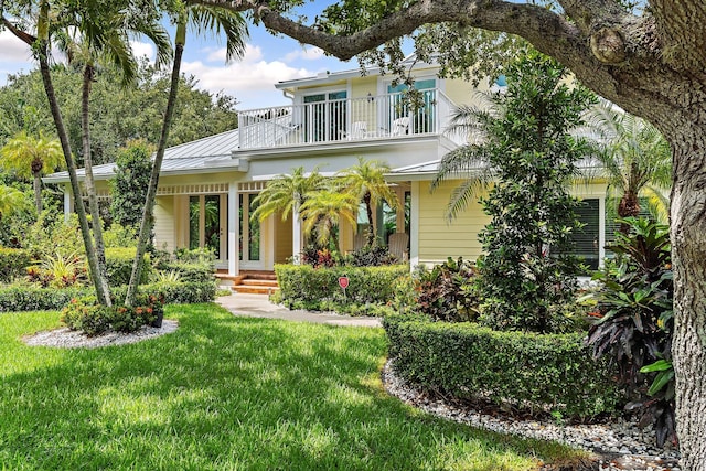 106 Henry Sewall Way, Sewalls Point, FL 34996 - back of property featuring a balcony, a yard, a standing seam roof, and metal roof