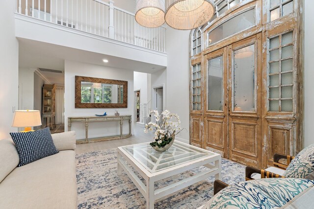 106 Henry Sewall Way, Sewalls Point, FL 34996 - living room featuring a high ceiling, wood finished floors, and recessed lighting