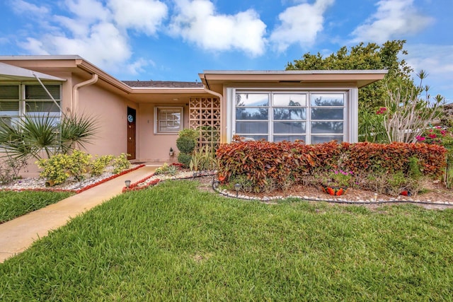 1232 W Club Dr W Unit D, Delray Beach, FL 33445 - view of front of home featuring a front yard and stucco siding
